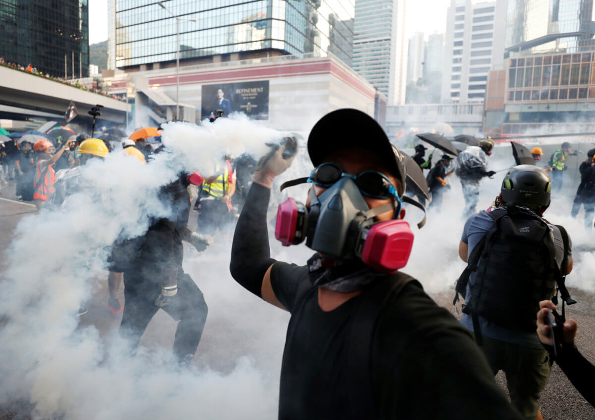 Hong Kong police fire tear gas, water cannon at petrol-bomb throwing ...