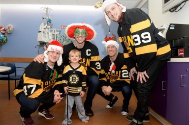 Boston Bruins players deliver holiday cheer to Children’s Hospital