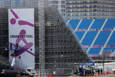 Construction workers are seen around spectators’ seat area in preparation for the Tokyo 2020 Olympic Games at Ariake Urban Sports Park in Tokyo