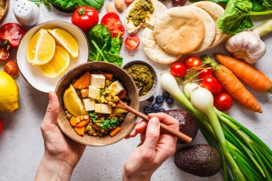 Healthy vegetarian food background. Vegetables, pesto and lentil curry with tofu.