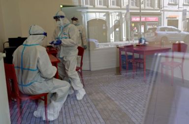 Medical staff members inside sampling station in Prague