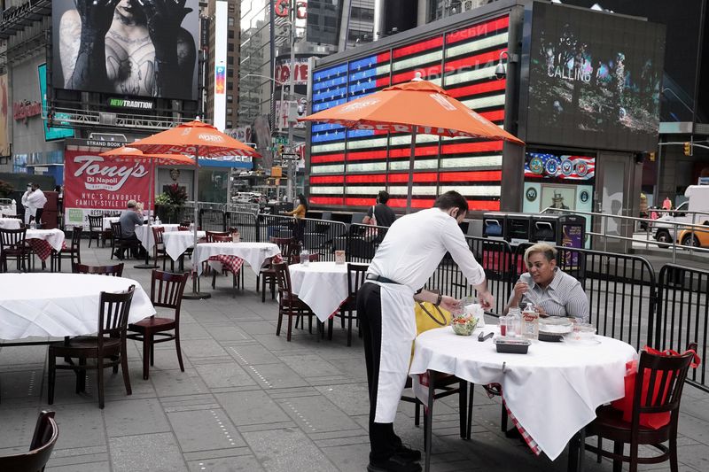 FILE PHOTO: Servers package food at a table at a