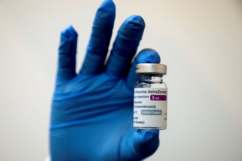 FILE PHOTO: A medical worker holds a bottle of AstraZeneca’s