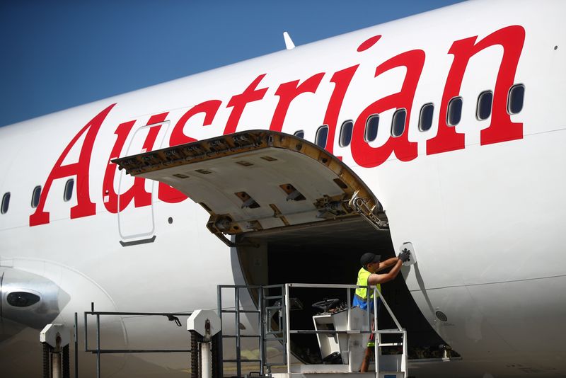 A worker checks an aircraft of Lufthansa’s unit Austrian Airlines