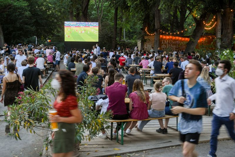 FILE PHOTO: People watch the EURO 2020 opening match in