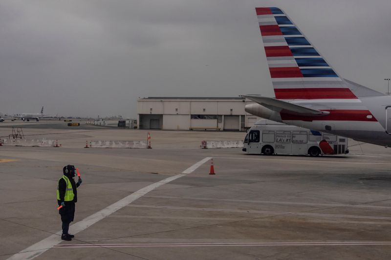 An American Airlines worker is seen as more than 1,400