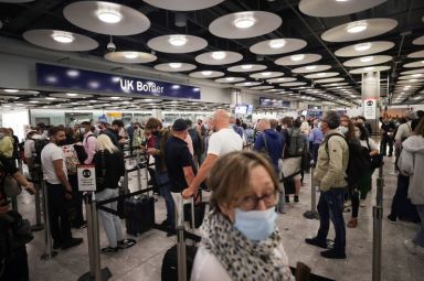 Arriving passengers queue at UK Border Control at the Terminal