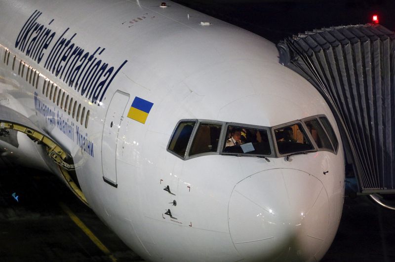 FILE PHOTO: Pilots sit in the cockpit of Ukrainian International