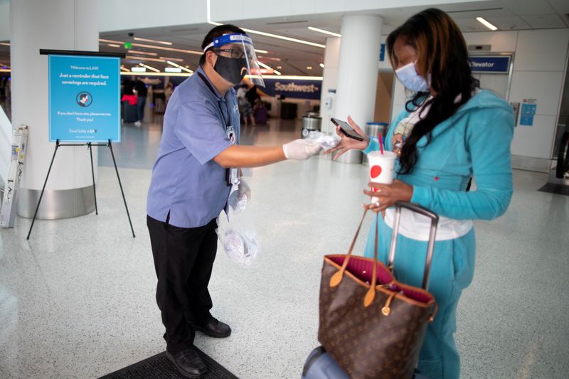 FILE PHOTO: Travel Safely Ambassador Carlos Hernandez hands out a