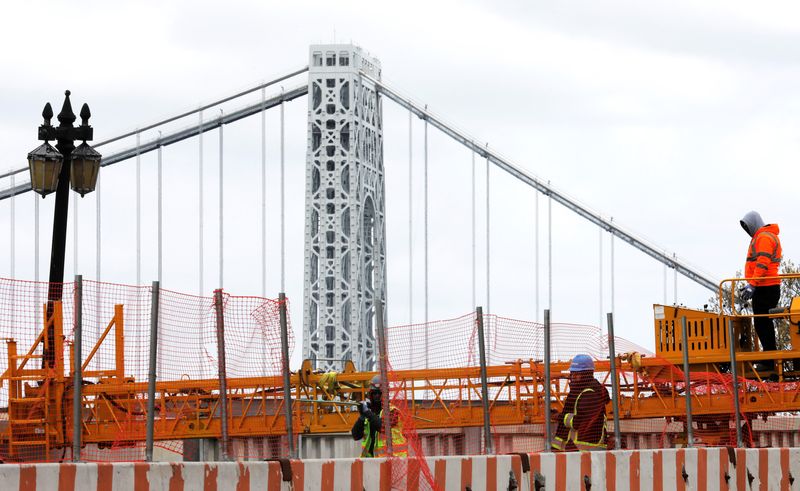 Construction workers are seen at the site of a large