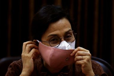 Indonesian Finance Minister Sri Mulyani wears protective masks during an