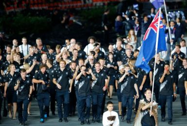New Zealand’s flag bearer Willis holds the national flag as