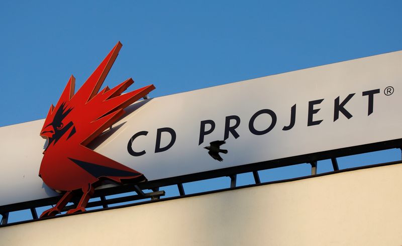 A bird flies in front of the Cd Projekt logo