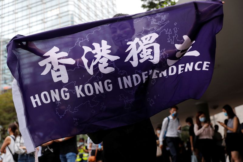 A pro-democracy demonstrator holds a flag supporting Hong Kong Independence