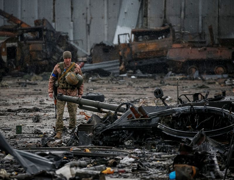 A Ukrainian service member inspects a compound of the Antonov