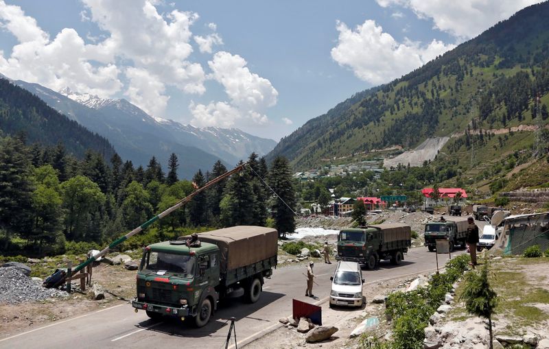 Indian army trucks move along a highway leading to Ladakh,