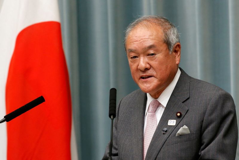 FILE PHOTO: Japan’s Olympics Minister Shunichi Suzuki speaks at a